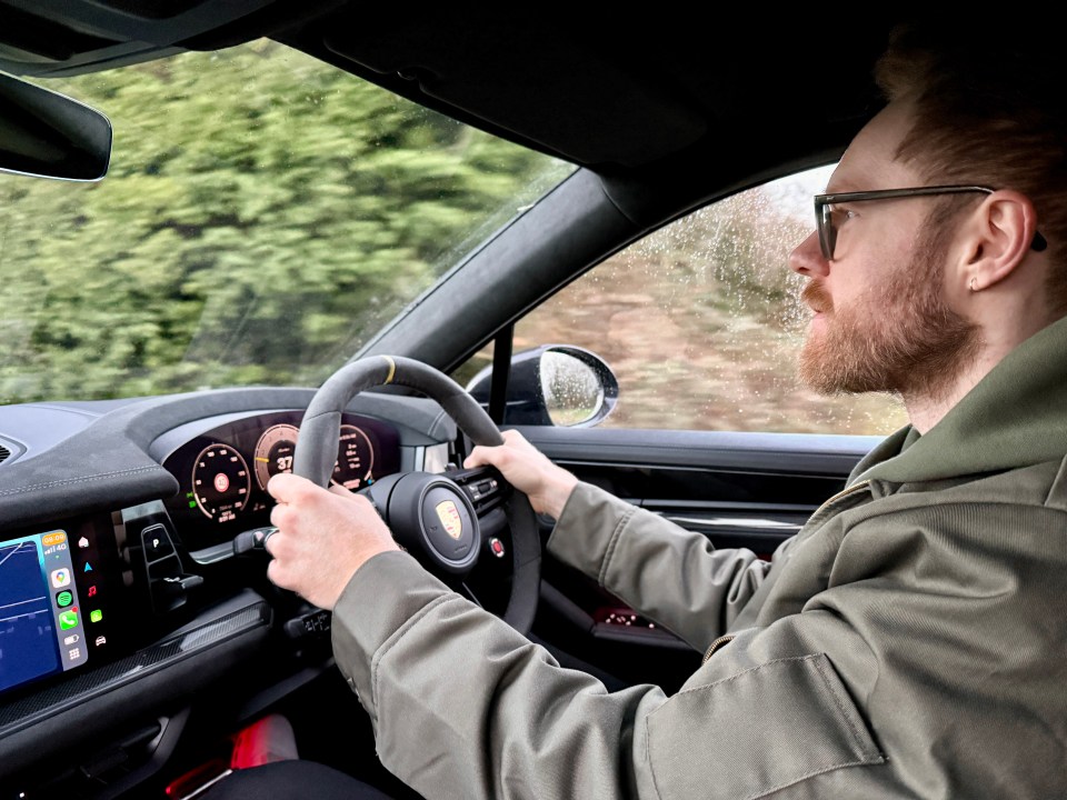 Man driving a Porsche Cayenne.