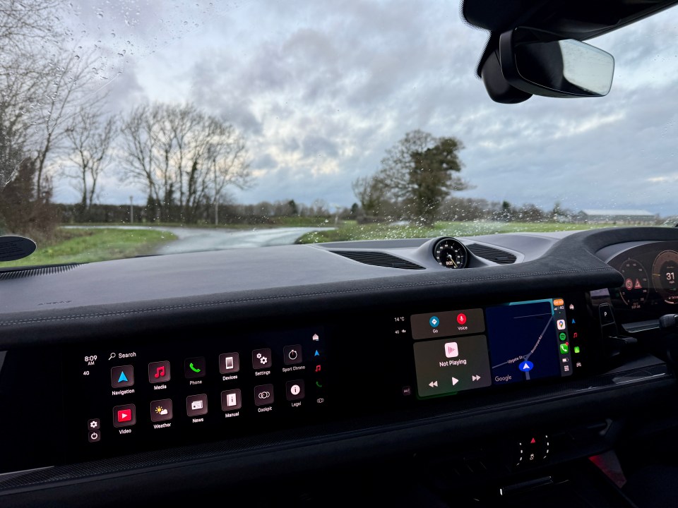 Porsche Cayenne dashboard showing navigation and media controls.