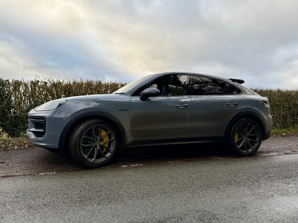 Gray Porsche Cayenne parked on a road.