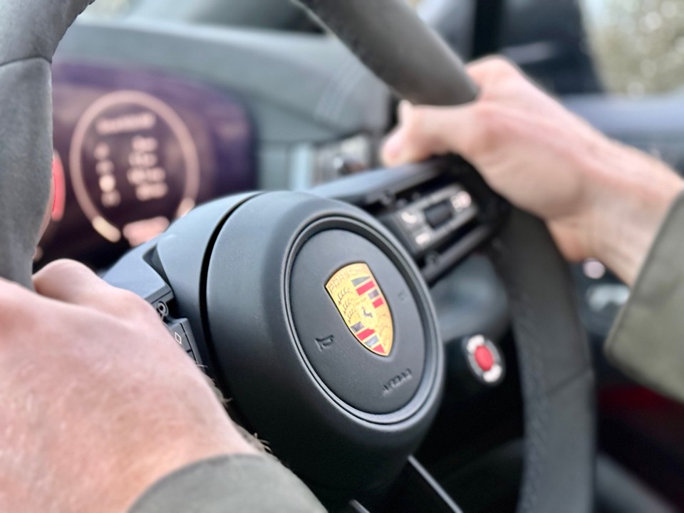 Close-up of a Porsche steering wheel.