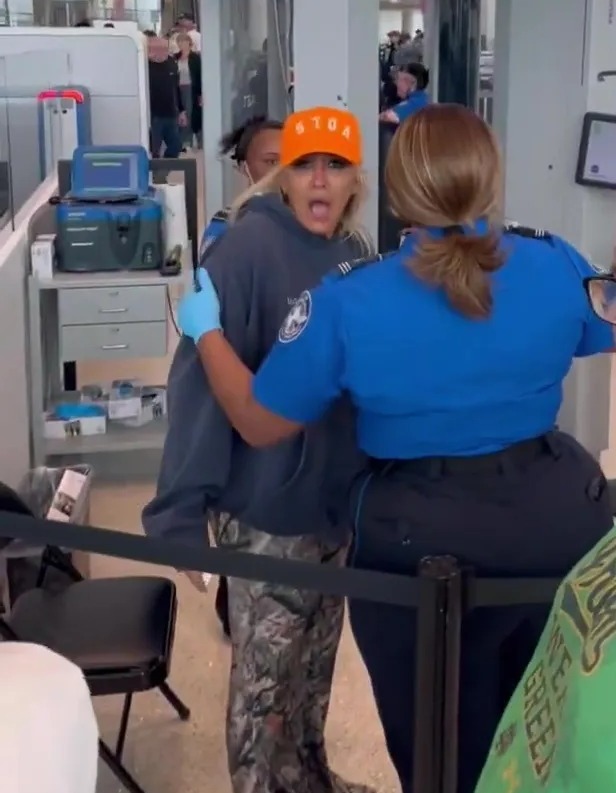 Woman arguing with TSA agent at airport security.