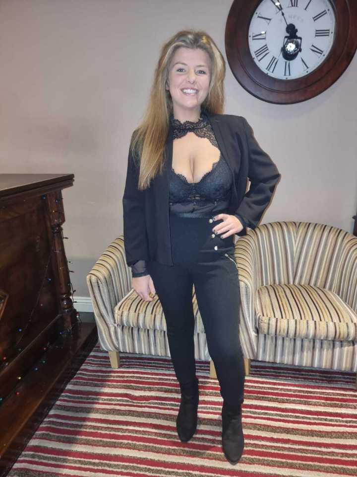 A woman in a black blazer and pants.