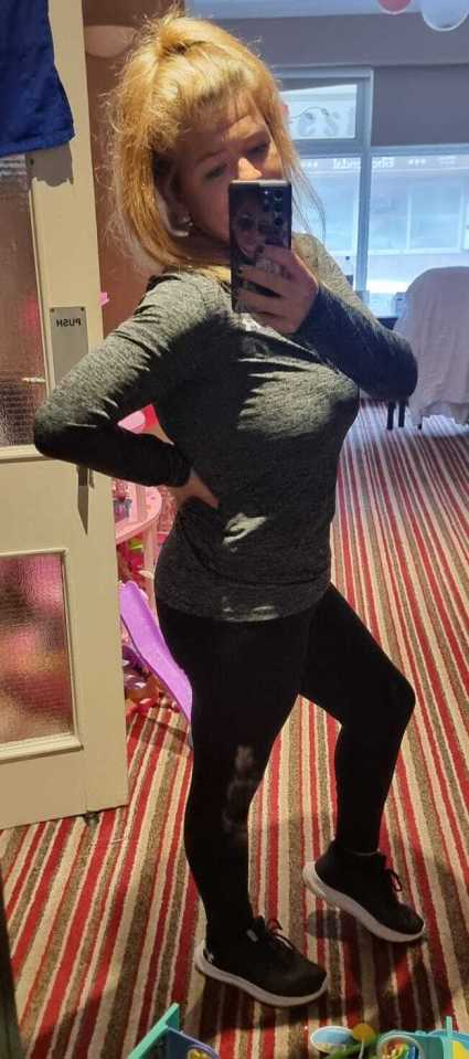 A woman in workout clothes taking a selfie.