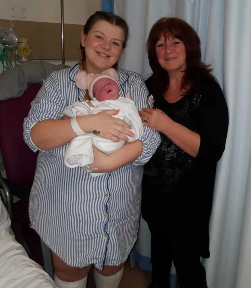 Mother, grandmother, and newborn baby in hospital room.