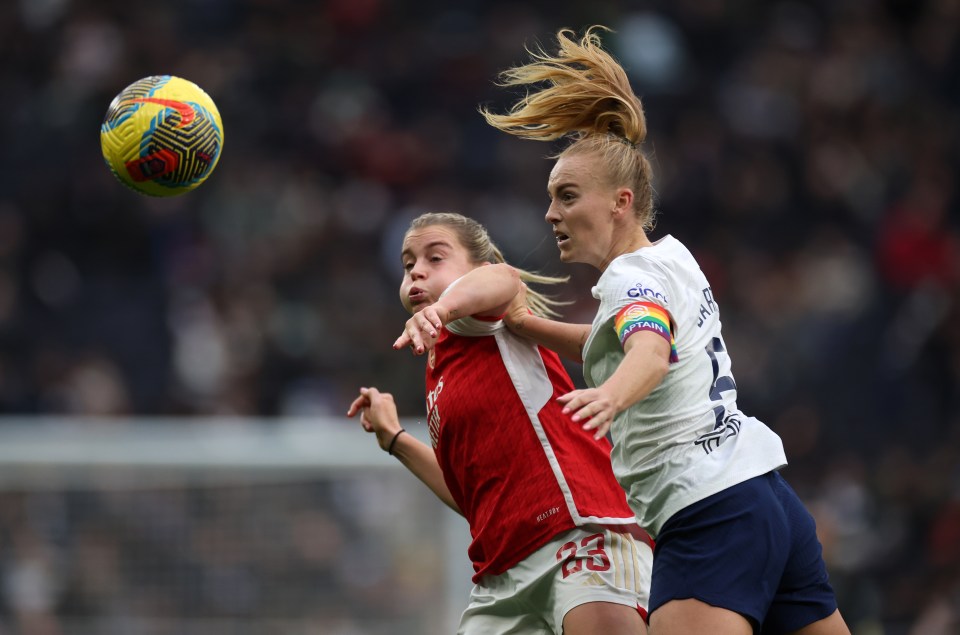 Photograph of a Tottenham Hotspur Women player and an Arsenal Women player vying for the ball.