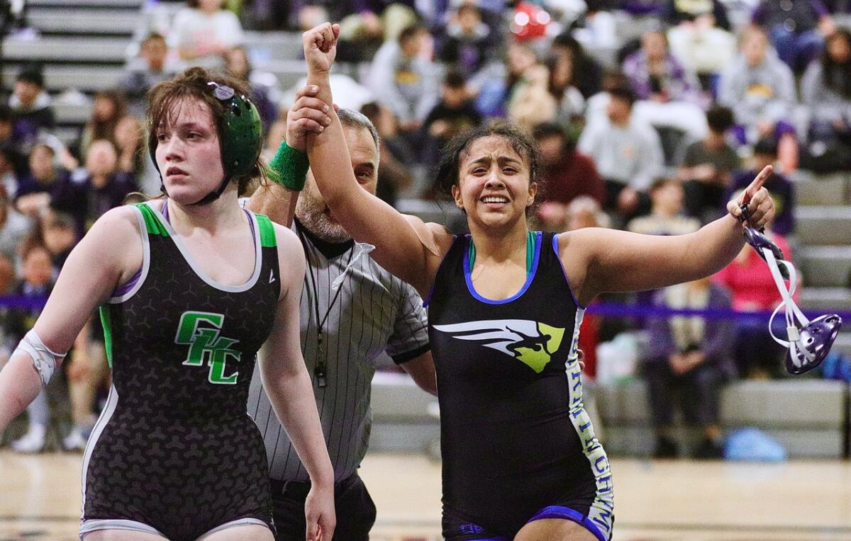 Birmingham’s Elizabeth Reyes celebrates, right, after pinning Granada Hills’ Maya Magana.