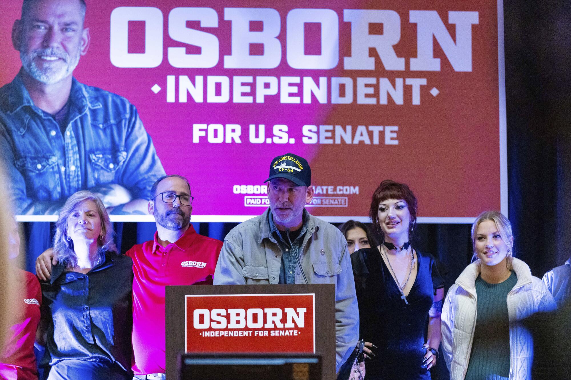 Nebraska Senate candidate Dan Osborn, center, speaks at an election night watch party.