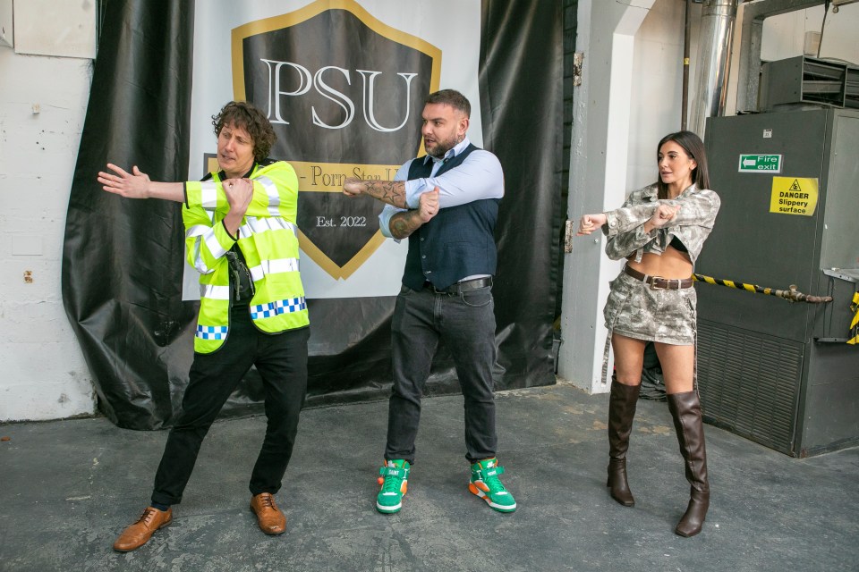 Three people stretching in front of a "Porn Star University" banner.