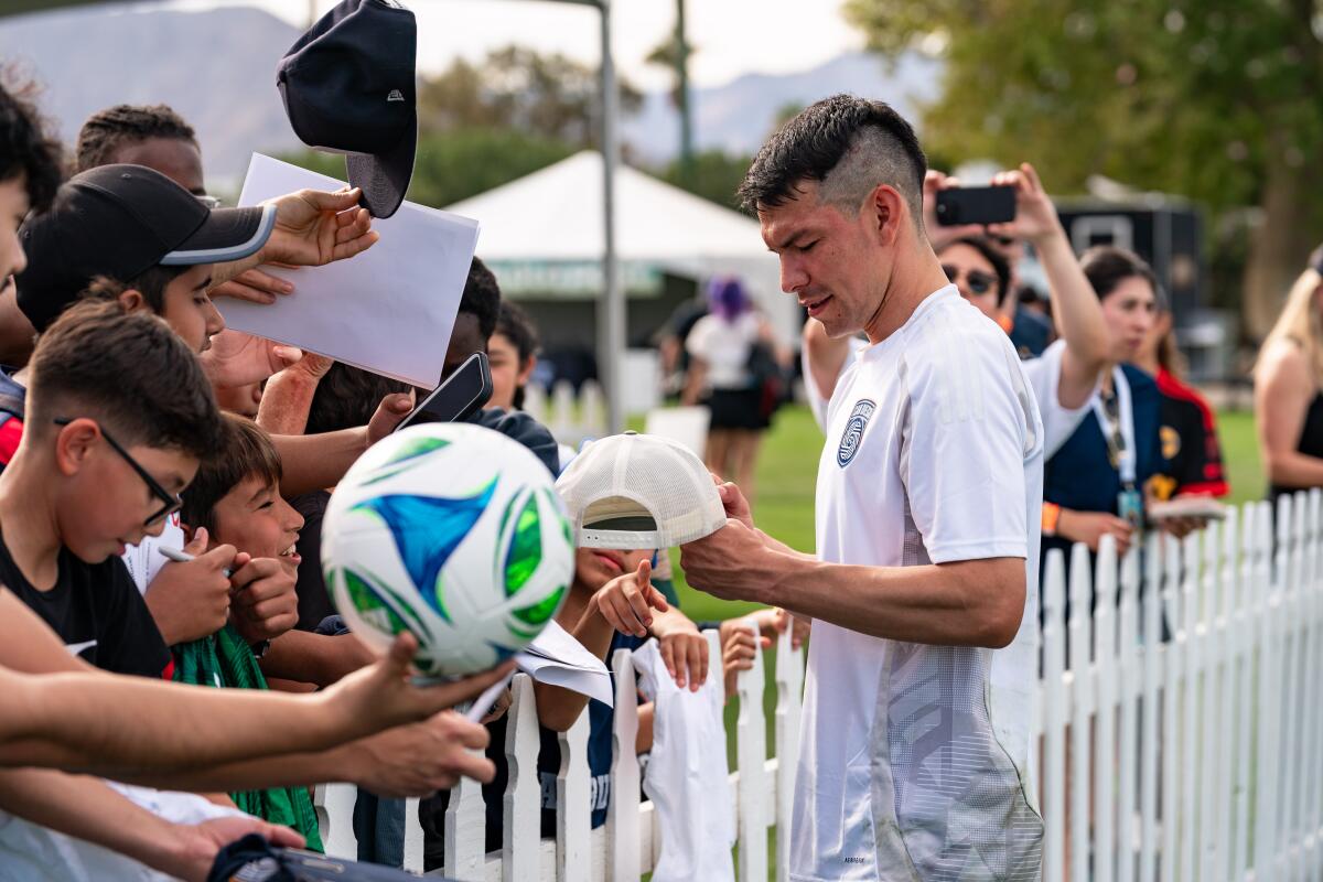 Soccer fans wait for San Diego FC's Chucky Lozano to sign autographs.