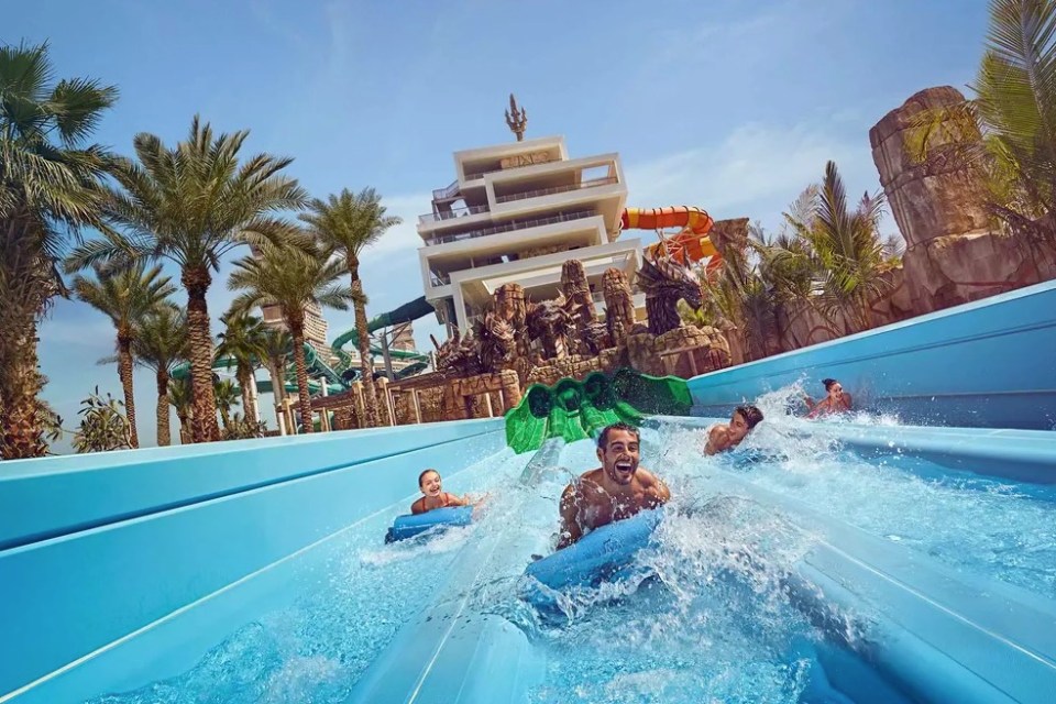 People enjoying water slides at Aquaventure World in Dubai.