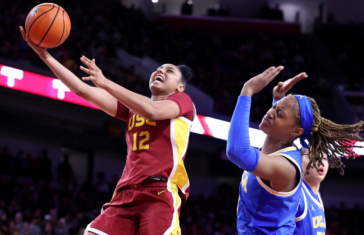 USC's JuJu Watkins scores after being fouled by UCLA's Janiah Barker while driving to the basket.