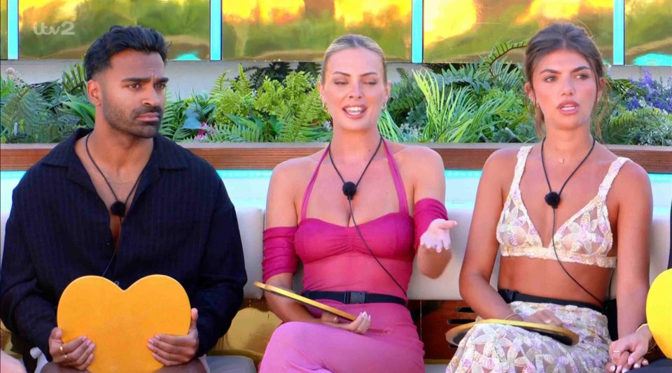 Three Love Island contestants discussing a couple's fate.