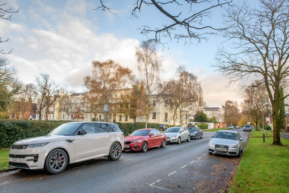 Cars parked on a street in Cheltenham, UK.