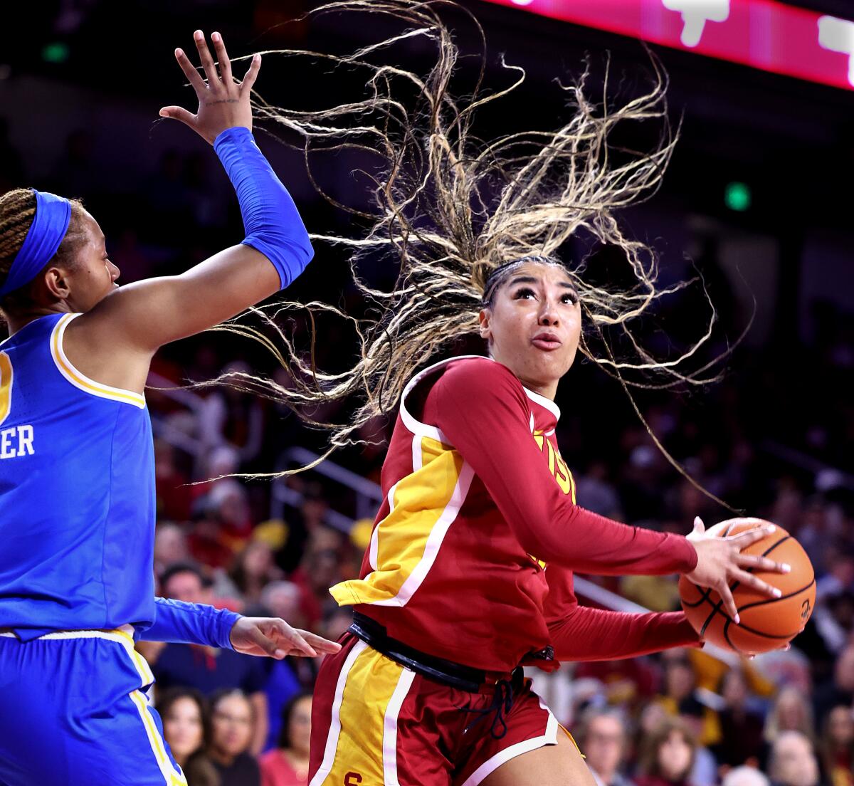 USC's Kennedy Smith drives to the basket on UCLA's Janiah Barker in the fourth quarter.