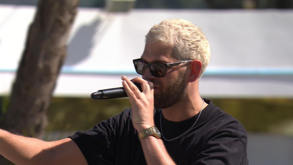 Nathan from Love Island All Stars speaking into a microphone.