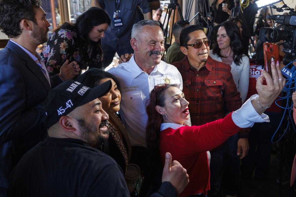 Riverside County Sheriff Chad Bianco takes a selfie with supporters.