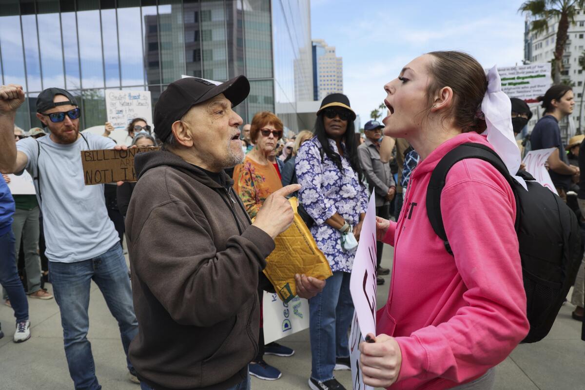 Alexis Linnea confronts a counter protester in front of City Hall.