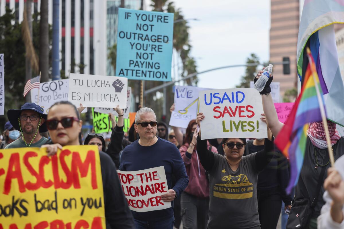 Protesters walk along Ocean Blvd for the nationwide "Not My President's Day" protest.