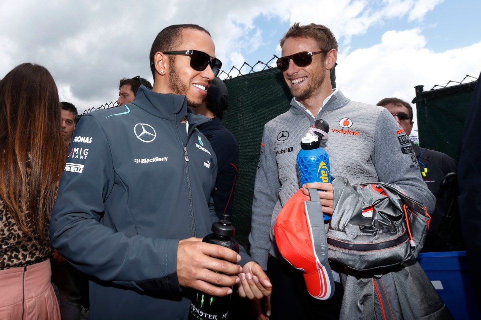 Lewis Hamilton and Jenson Button at a racetrack.