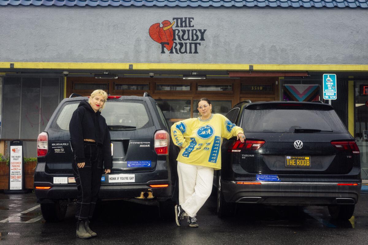 Mara Herbkersman and Emily Bielagus, co-founders of the lesbian bar, The Ruby Fruit, sell branded bumper stickers that read: "keep honking. i'm listening to THE INDIGO GIRLS" for $5 each online.