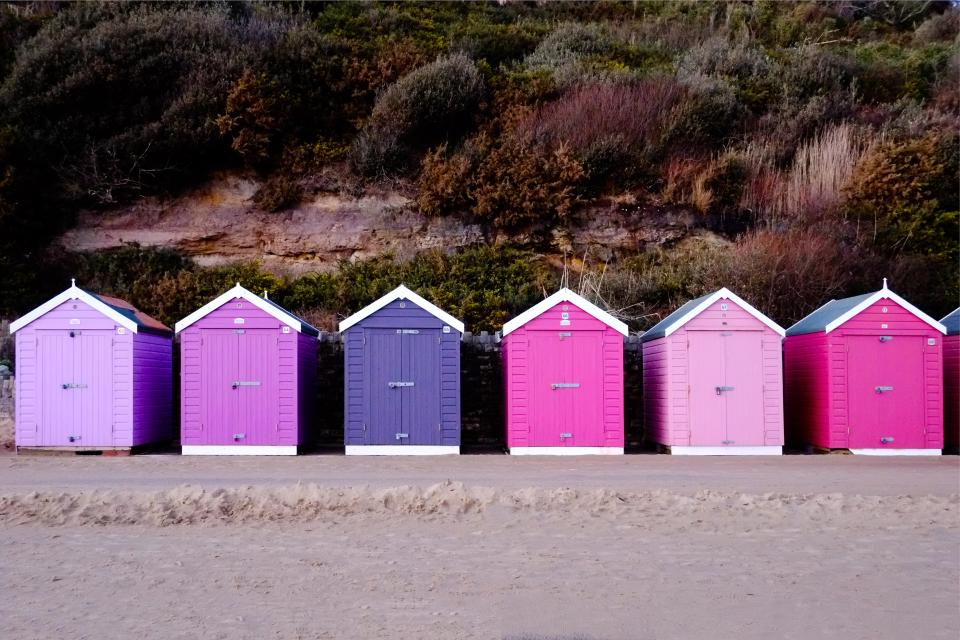 Row of brightly colored beach huts.