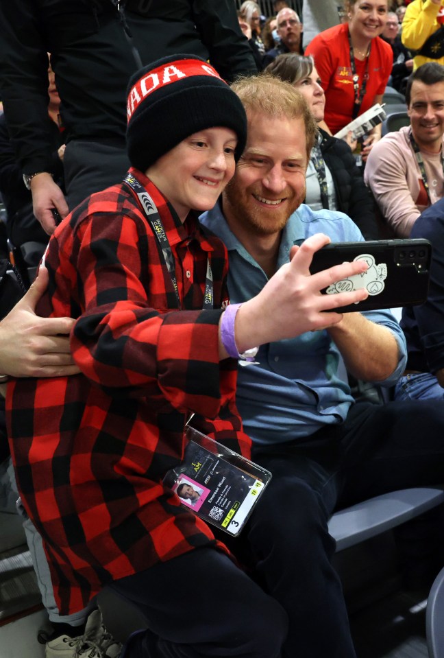 Prince Harry taking a selfie with a young Invictus Games participant.