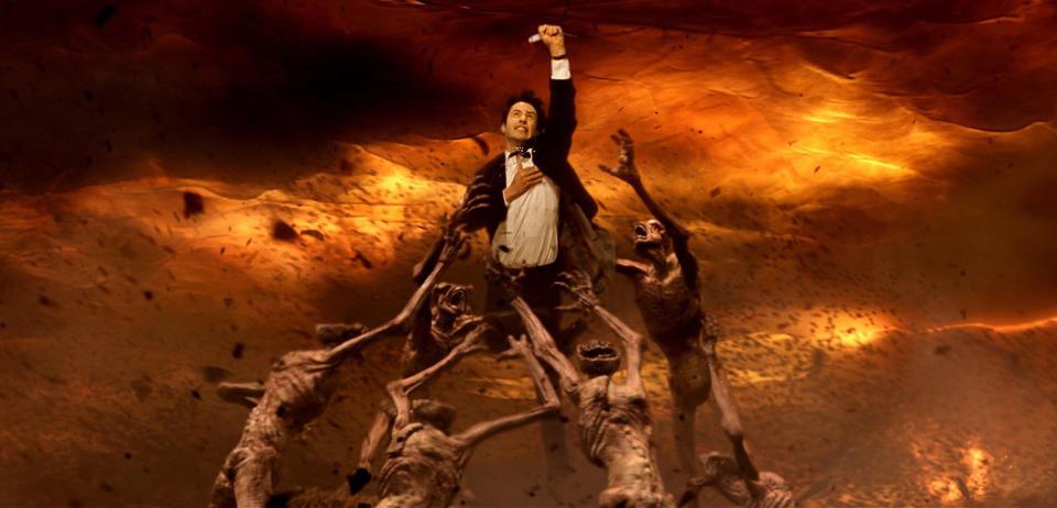 Keanu Reeves as John Constantine being pulled into hell by demonic creatures.