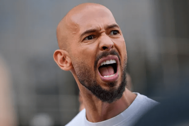 Close-up of a bald man shouting.