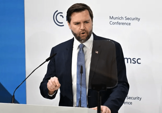 Man in suit speaking at a podium at the Munich Security Conference.