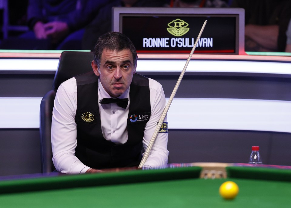 Ronnie O'Sullivan at a snooker table.