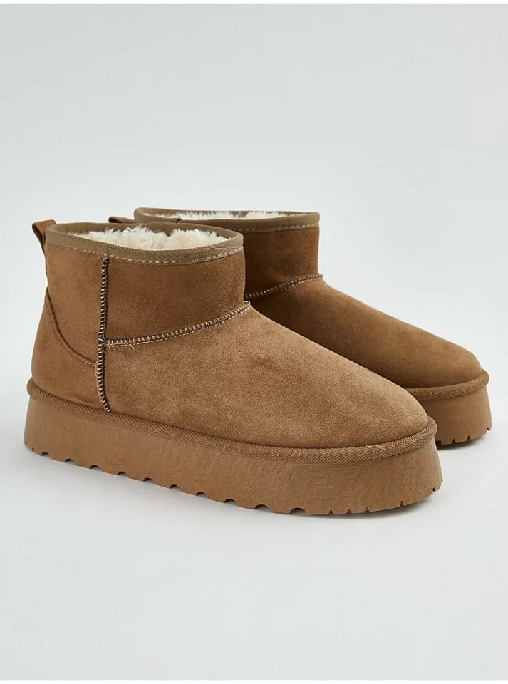 Pair of brown suede ankle boots with light brown fleece lining.