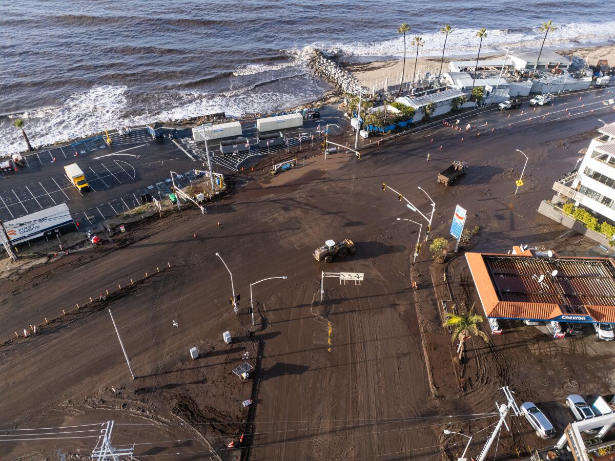 A mudslide is cleared from Pacific Coast Highway at Sunset Boulevard in Pacific Palisades after last week's storm.