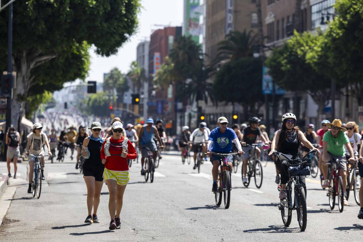 A large group of bikers and runners take over a street for CicLAvia.