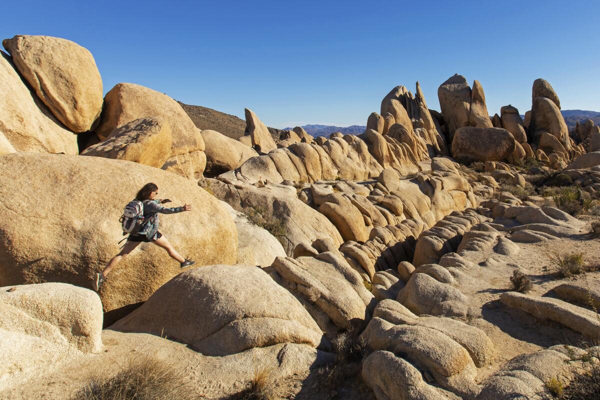 A person climbing on huge rocks