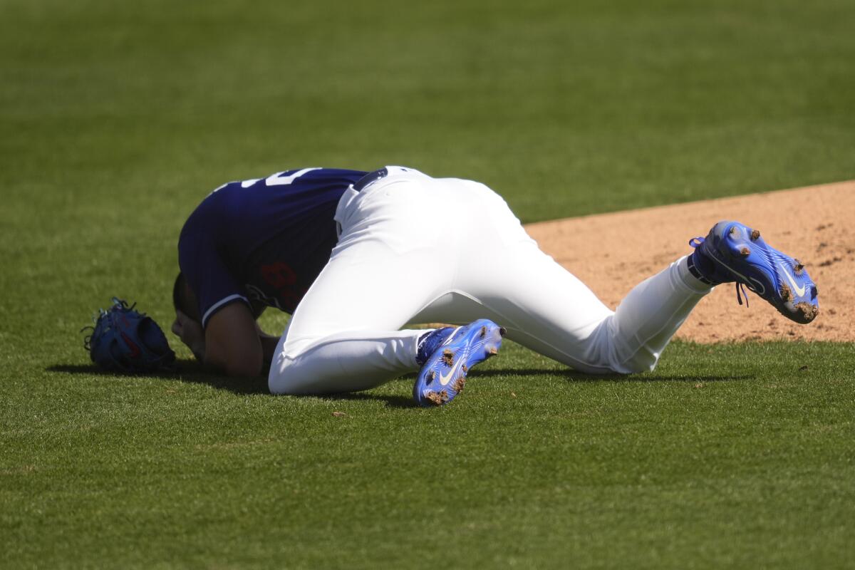 Dodgers pitcher Bobby Miller reacts after being hit by a line drive of the bat of Chicago's Michael Busch.