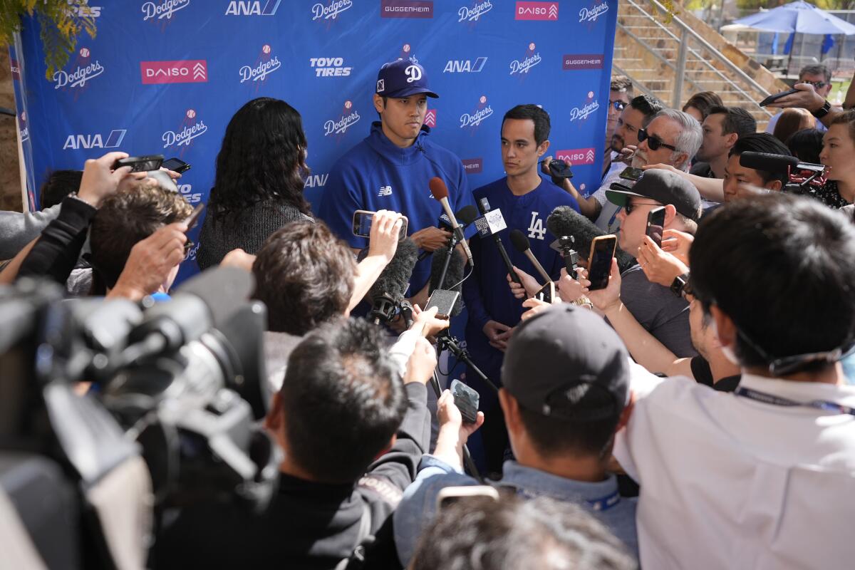 Dodgers two-way player Shohei Ohtani speaks to reporters Thursday at Camelback Ranch.