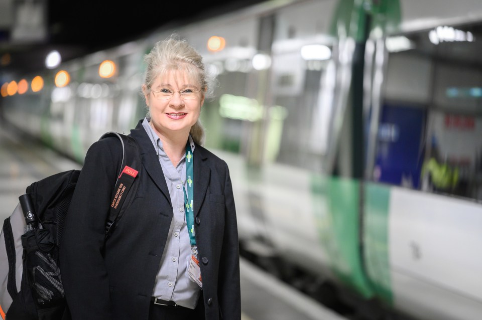 Woman standing at a train station.