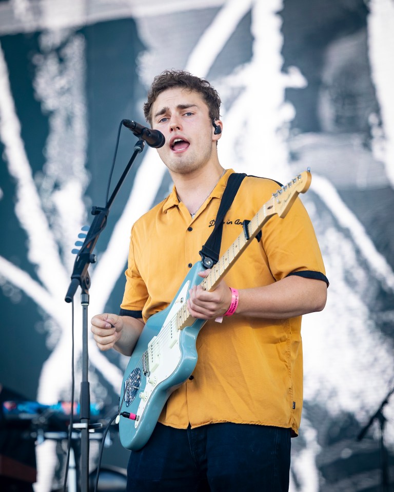 Sam Fender performing at a music festival.