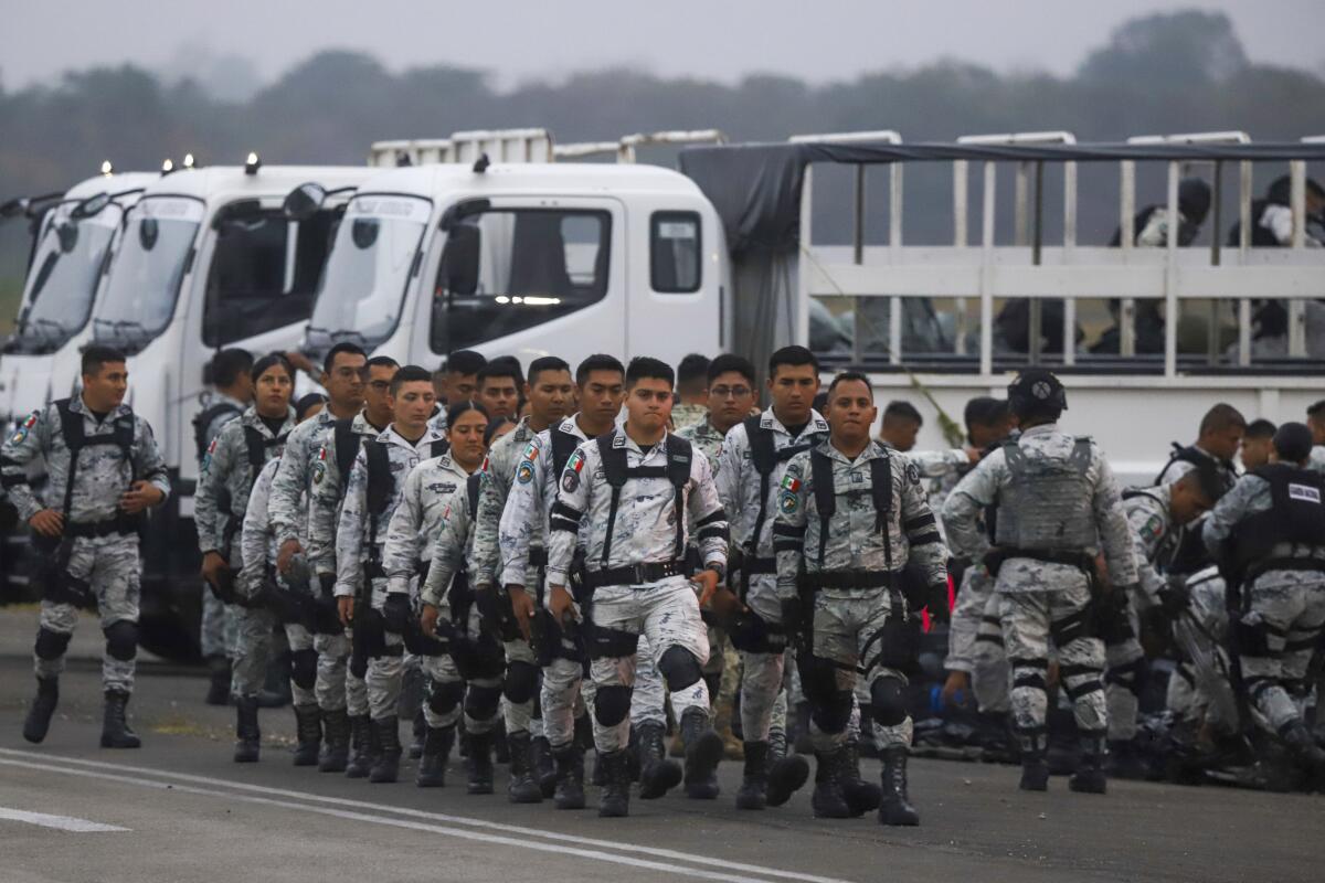 Mexican national guards prepare to board an aircraft.