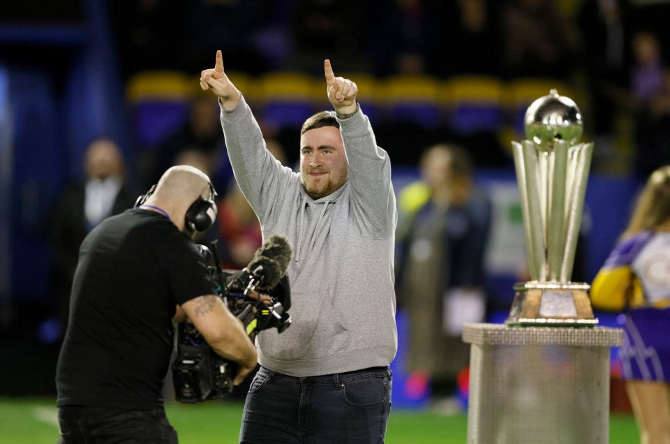 Luke Littler with his PDC championship trophy before the Betfred Super League match at the Halliwell Jones Stadium, Warrington. Picture date: Friday February 21, 2025. PA Photo. See PA story RUGBYL Warrington. Photo credit should read: Richard Sellers/PA Wire. RESTRICTIONS: Use subject to restrictions. Editorial use only, no commercial use without prior consent from rights holder.