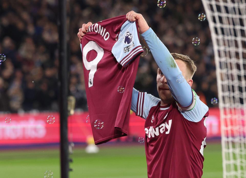 Jarrod Bowen of West Ham United celebrates a goal by holding up Michail Antonio's jersey.