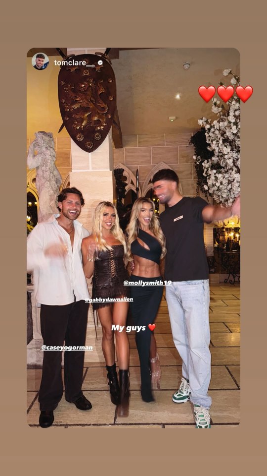 Gabby and Casey from Love Island with friends at a restaurant.