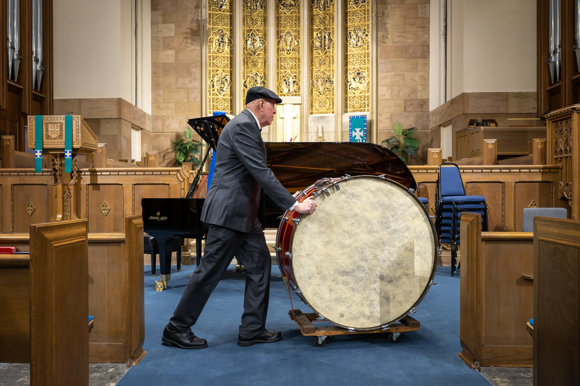 Palisades Symphony member Stan Hecht rolls his bass drum into Westwood United Methodist Church.