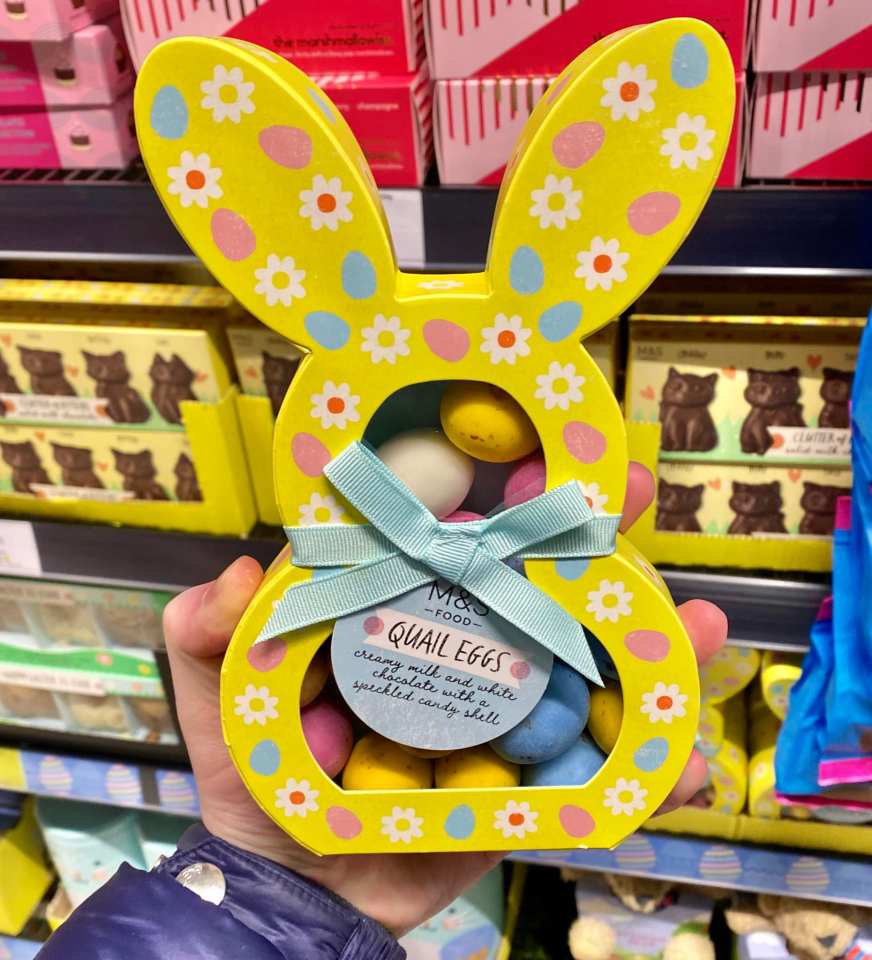 Hand holding yellow bunny-shaped box of M&S quail eggs.