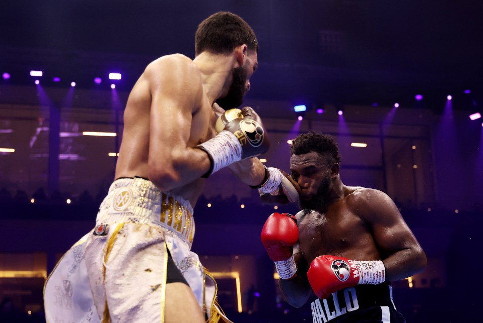 Hamzah Sheeraz punches Carlos Adames in a boxing match.