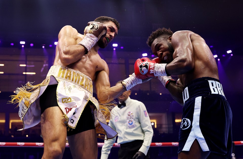 Hamzah Sheeraz punches Carlos Adames during a WBC World Middleweight Title fight.