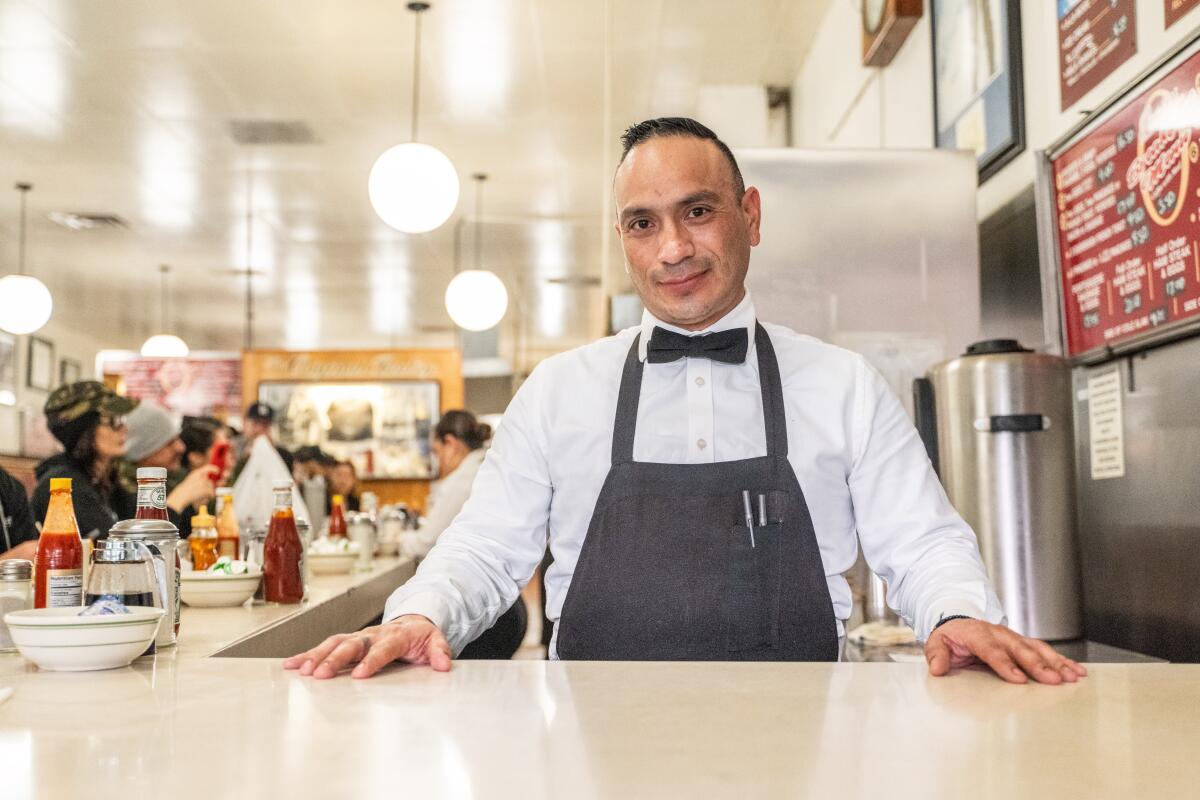 Server Alejandro Ortiz behind the counter at the Original Pantry Cafe.