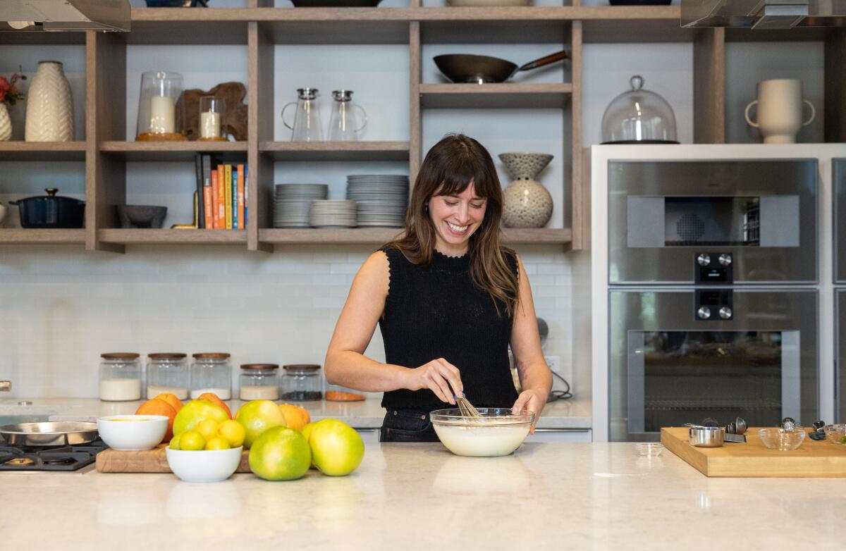 Hannah Ziskin stirs a bowl of ingredients behind the counter at the Los Angeles Times test kitchen 