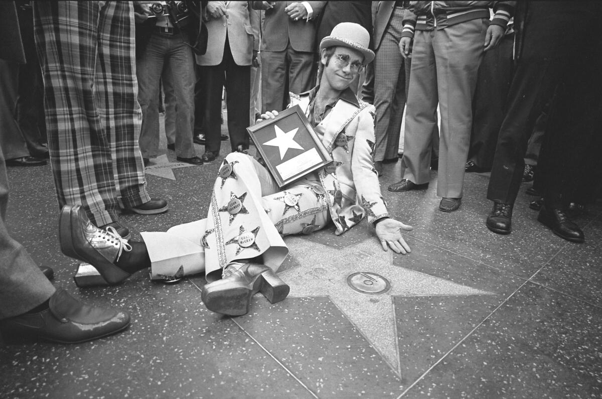 Elton John receives his star on the Hollywood Walk of Fame in 1975.