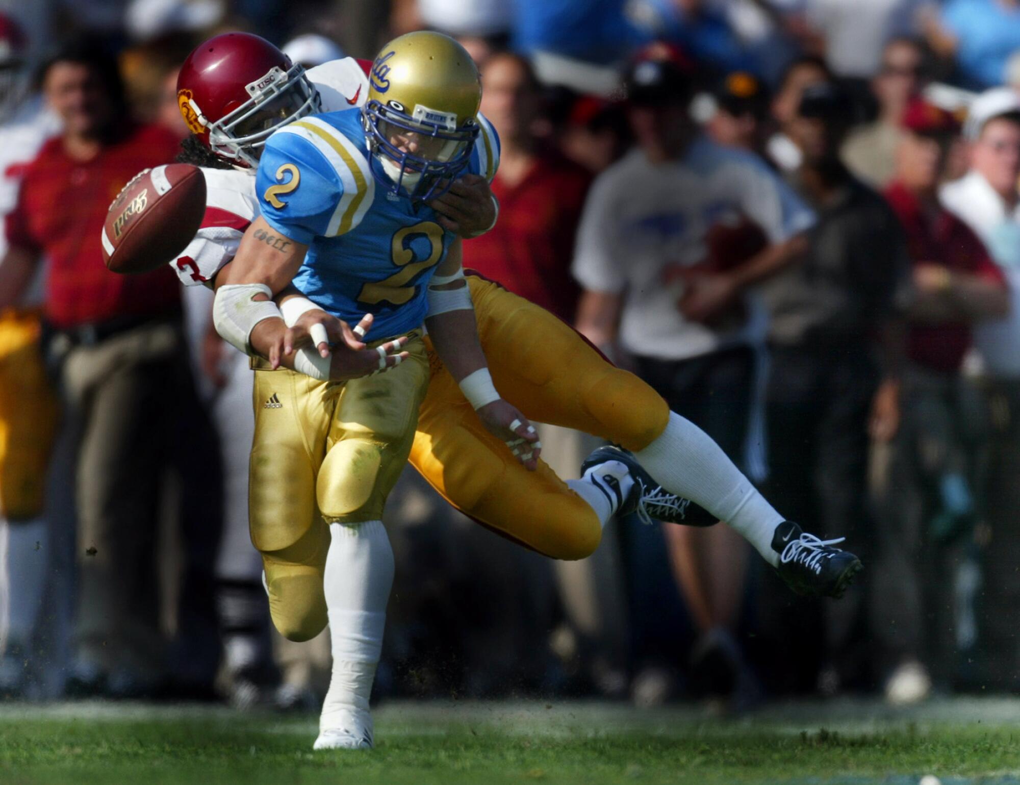 USC's Troy Polamalu causes UCLA's Tyler Ebell to fumble during a football game at the Rose Bowl.